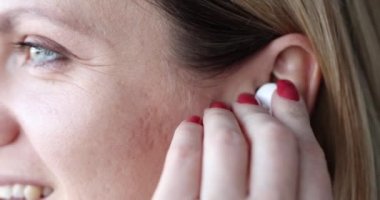 Genç kadın müzik dinleyerek kablosuz kulaklık kullanıyor. Müzik ve ses bluetooth aygıtı kavramı