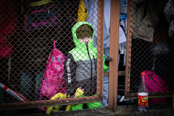 Przemysl, Poland - February 27 2022: Ukrainian children after crossing the Ukrainian-Polish border in the Polish city of Przemysl after fleeing Ukraine because of Russia's full-scale invasion. 