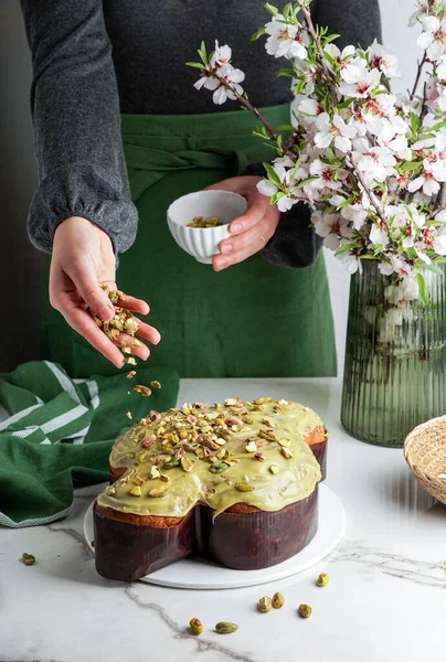 Kadında Kolomba di Pasqua, el çırpma, geleneksel İtalyan paskalya güvercini pastası, yeşil şam fıstığı jölesi, taze bahar çiçekleri, pasqua keki.