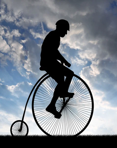 Silhouette cyclist on historic bicycle — Stock Photo, Image