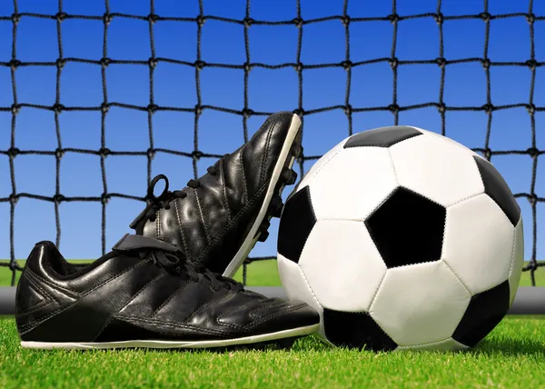 Jalkapallo ja kengät — kuvapankkivalokuva