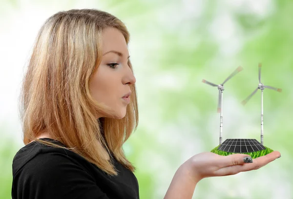 Girl blowing on the wind turbines — Stock Photo, Image