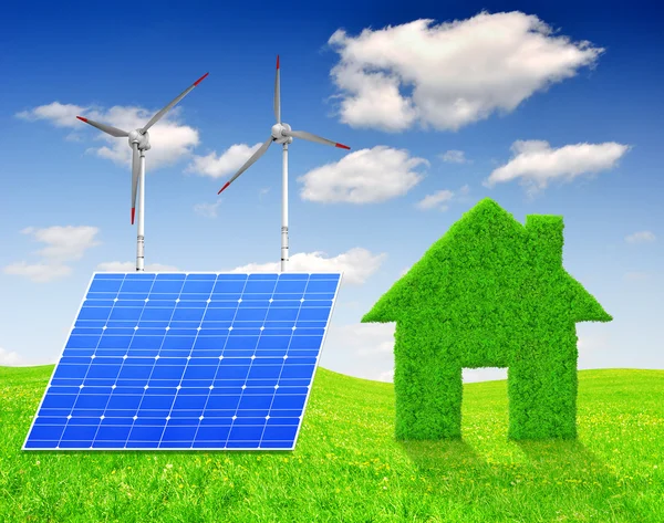 Green grass house symbol with solar panel and wind turbines — Stock Photo, Image