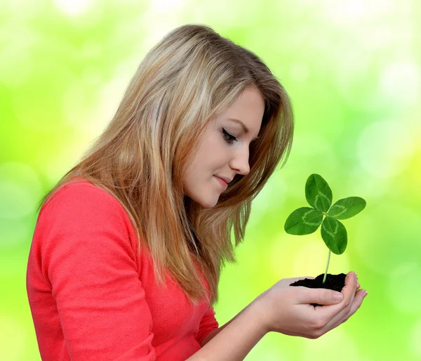 Girl holding in hand clover quarterfoil — Stock Photo, Image