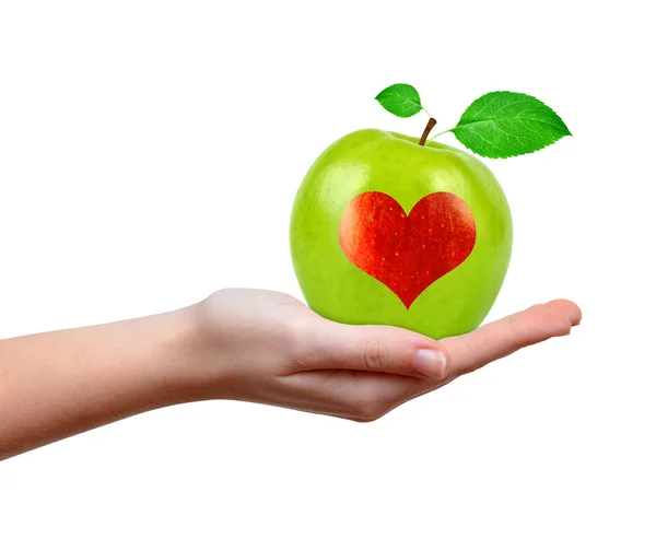 Hand holding green apple with heart — Stock Photo, Image