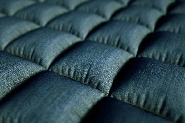 3D illustration of a realistic sofa structure. 3D graphics, gray little pillows, sofa cover. 3D graphics, close-up