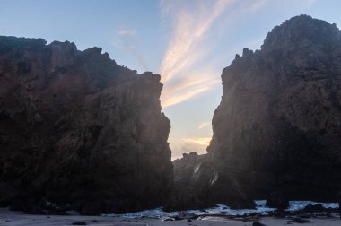 Büyük Sur, Kaliforniya 'daki Pfeiffer plajındaki kayalık kayalıklar arasında dalgalar geliyor..