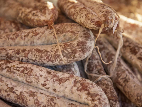 Eco-friendly products on a market stall . Smoked sausage , made according to traditional French recipes — Stock Photo, Image