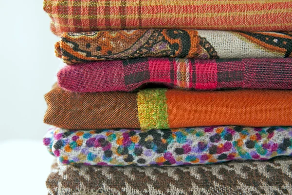 Stack of colorful scarves on the counter — Stock Photo, Image