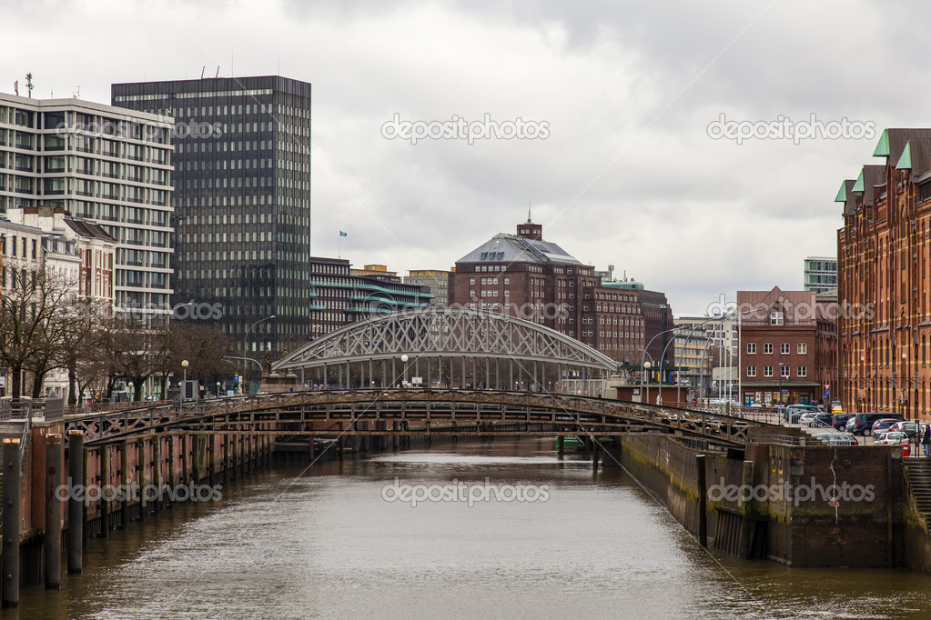Hamburg, Germany , February 19, 2013. Bridge over the canal and old buildings warehouses and offices in the historic city in cloudy winter weather