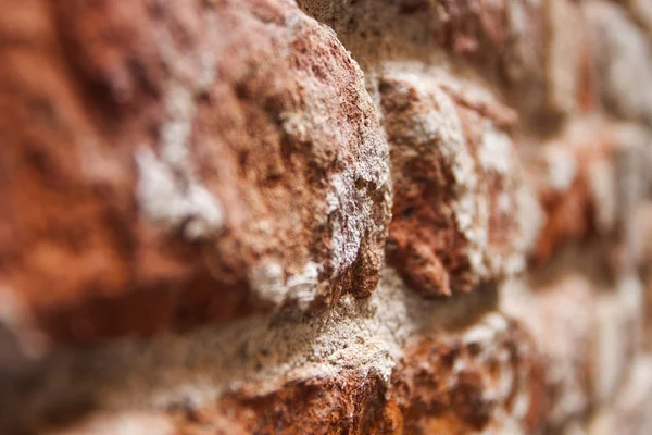 Old wall of chipped bricks — Stock Photo, Image
