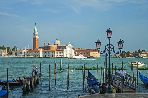 Venice, Italy, June 20, 2012. View of the piers for gondolas and Cathedral of San Giorgio Maggiore on the island of San Giorgio Maggiore from the promenade of San Marco — Stock Photo, Image
