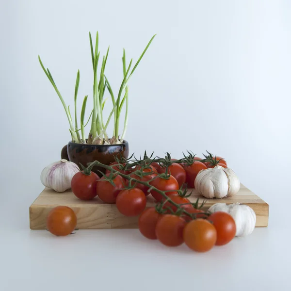 Cherry tomato varieties , garlic and garlic sprouts in salads