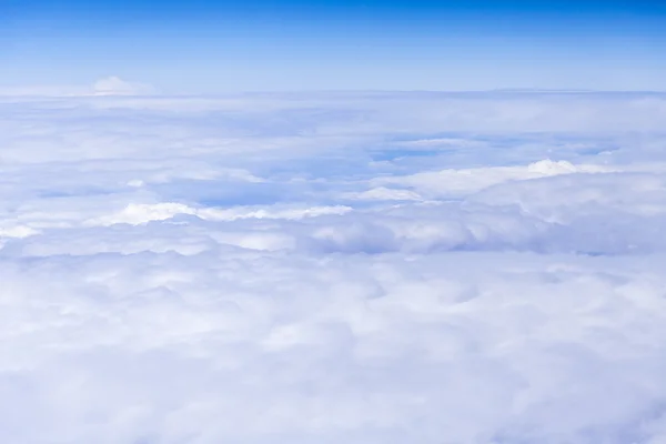 View of a layer of dense cumulus clouds from a plane window — Stock Photo, Image