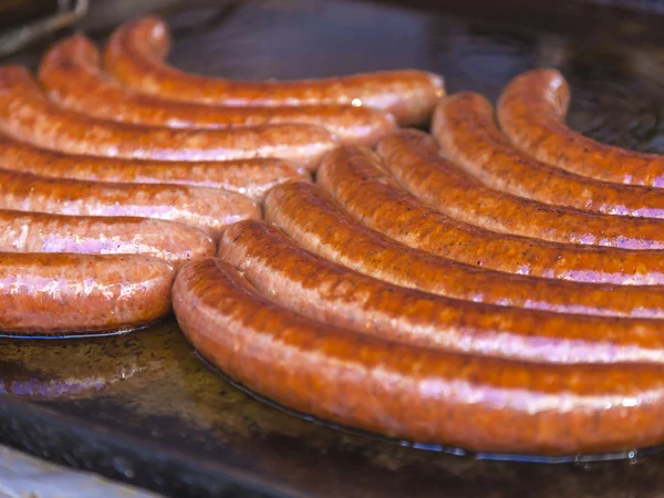 Budapest, Hungary, Fair. Hungarian sausages fried in a pan in the outdoor cafes — Stock Photo, Image