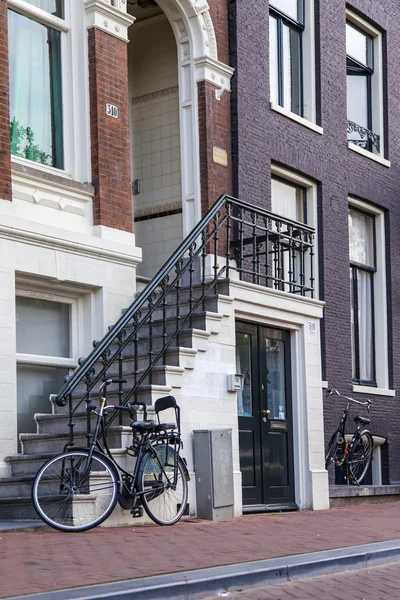 Amsterdam, the Netherlands, Typical architectural details of facades of the town houses constructed of the burned brick — Stock Photo, Image