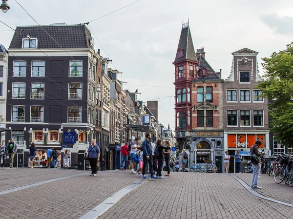 Amsterdam, Niederlande, am 7. Juli 2014. Touristen und Bürger gehen die Straße hinunter — Stockfoto