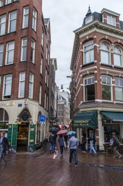 Amsterdam, Hollanda, 7 Temmuz 2014 tarihinde. turistler ve vatandaşların Yağmurlu hava caddeden aşağı git