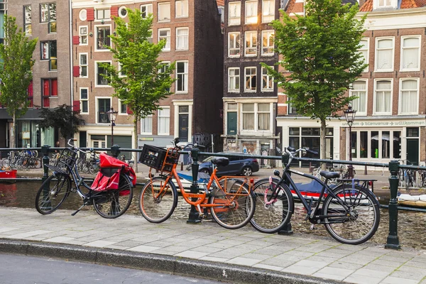 Amsterdam, Hollanda, üzerinde 10 Temmuz 2014. Bisiklet kanal kıyısında şehrin cadde üzerinde park edilmiş