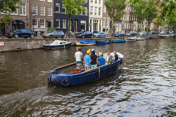 Amsterdam, Netherlands, on July 10, 2014. Walking boat are moving by channel — Stock Photo, Image