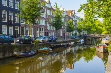 Amsterdam, Hollanda, üzerinde 10 Temmuz 2014. Kanal ve bankada demirleyen tekneleri banka eski binalar ile tipik kentsel görünümü