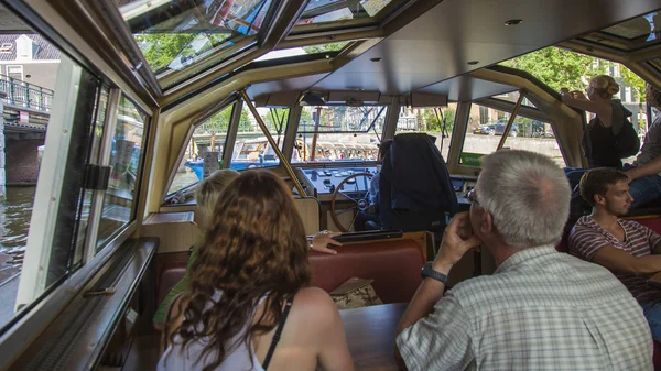 Amsterdam, Netherlands, on July 10, 2014. Tourists sight-see the city from a board of the walking ship — Stock Photo, Image