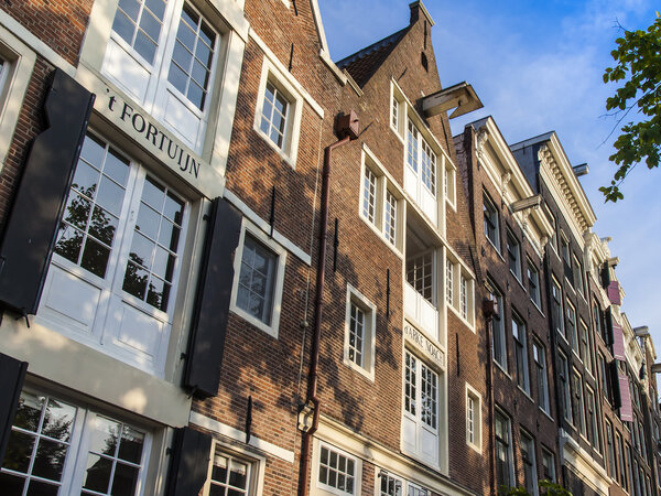 Amsterdam, Netherlands, on July 10, 2014. Typical architectural details of old buildings on the bank of the channel