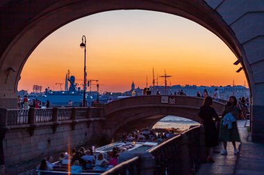 St. Petersburg, Russia, July 24, 2021. View of the Zimnyaya Kanavka canal connecting the Moika and Neva rivers, the Hermitage bridge and its picturesque embankments at sunset time. clipart