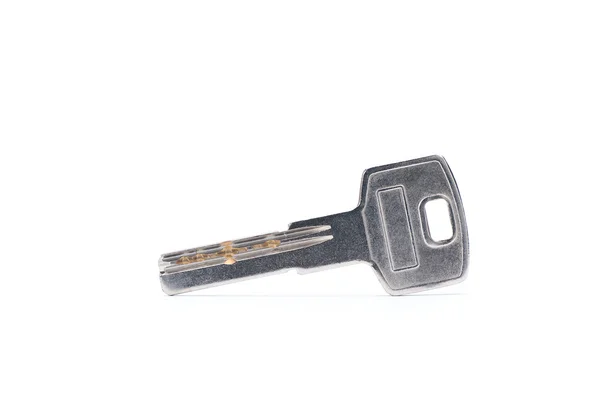 Серебристый ключ на белом фоне с вырезкой пути Стоковое Фото