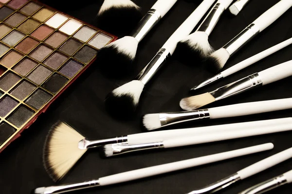 Make-up brushes in dark background — Stock Photo, Image