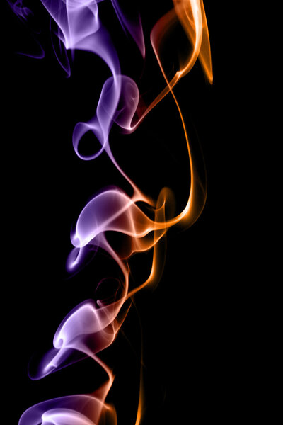 Purple and yellow smoke in black background