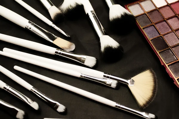 Make-up brushes in dark background — Stock Photo, Image