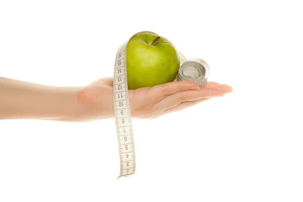 Woman's hand with green apple and tape measure — Stock Photo, Image