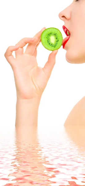 Woman's hand with a piece of kiwi — Stock Photo, Image