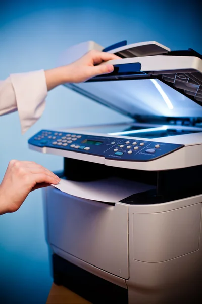 Woman's hand with working copier — Stock Photo, Image