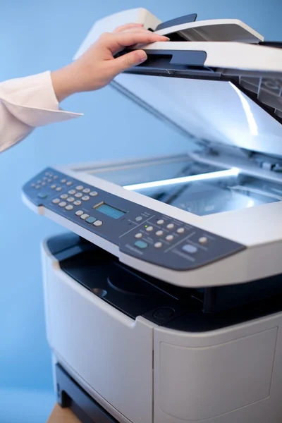 Woman's hand with working copier — Stock Photo, Image