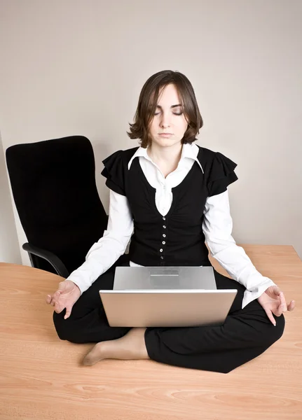 Young woman sitting in lotus pose — Stock Photo, Image