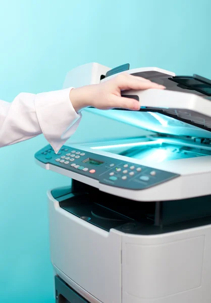 Woman's hand with working copier — Stock Photo, Image