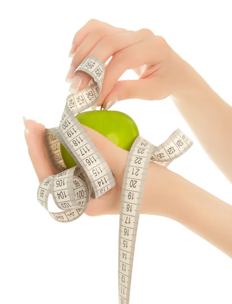 Woman's hands holding green apple with measuring tape isolated — Stock Photo, Image