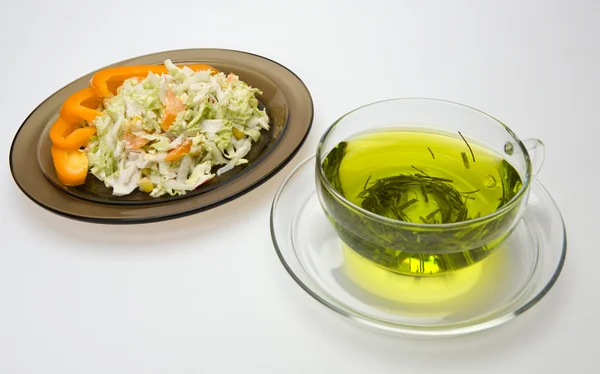 A cup of tea and a plate of salat — Stock Photo, Image