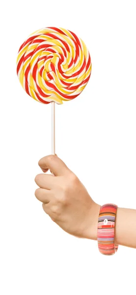 Woman's hands with lollipop on the white background — Stock Photo, Image