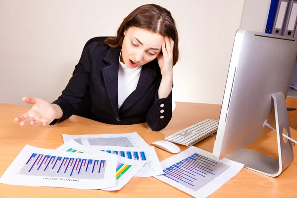 Displeased woman with a financial reports — Stock Photo, Image