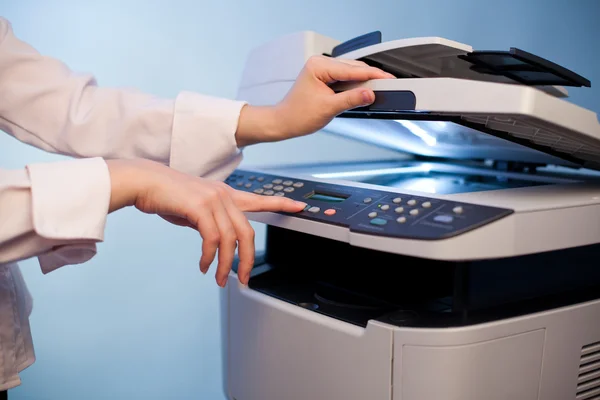 Woman's hand with working copier — Stock Photo, Image