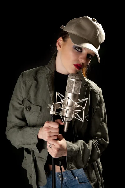 Girl in green jacket holding microphone — Stock Photo, Image