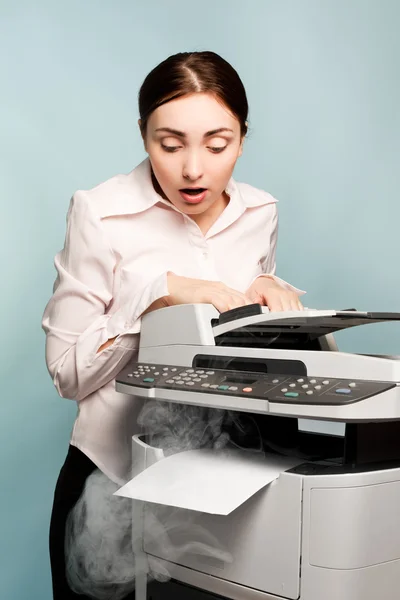 Businesswoman with smoking copier — Stock Photo, Image