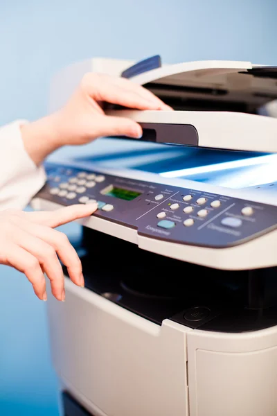 Woman's hand with working copier — Stock Photo, Image