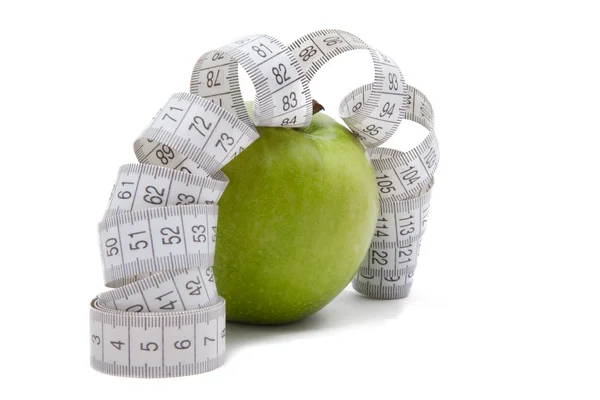 Green apple with tape measure — Stock Photo, Image