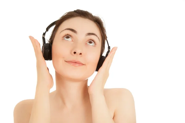 Naked woman listening to music — Stock Photo, Image