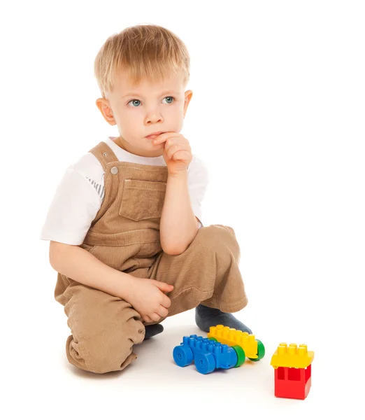 Criança cuidadosa brincando com brinquedos isolados — Fotografia de Stock