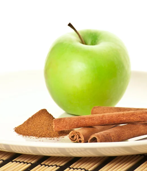 Picture of green apple and spices (focus on cinnamon) — Stock Photo, Image